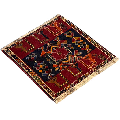 Poshti rug diagonal view: red field, dark blue border with geometric motifs
