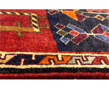 Poshti rug close-up of the edge: red and dark blue pattern with fringes