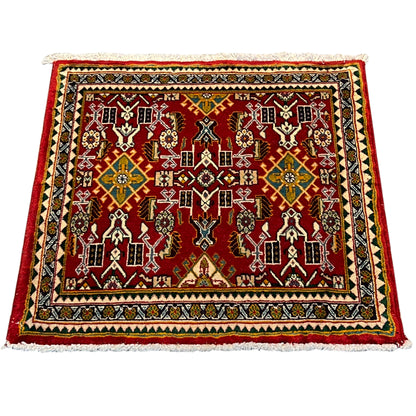 Carpet with a red ornamental pattern, multicolored border, square, fringes