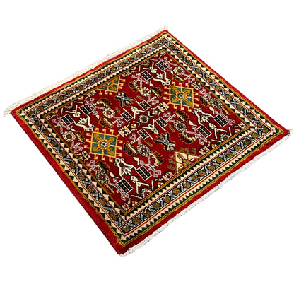 Rug with a red ornamental field and multicolored border, square-shaped