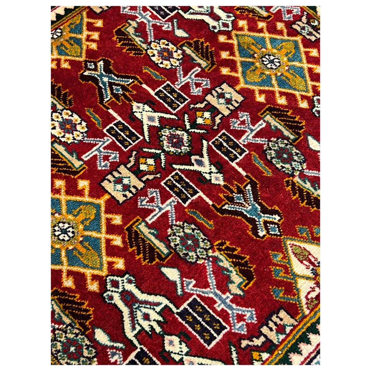 Detail of the carpet pattern: red area with geometric ornaments