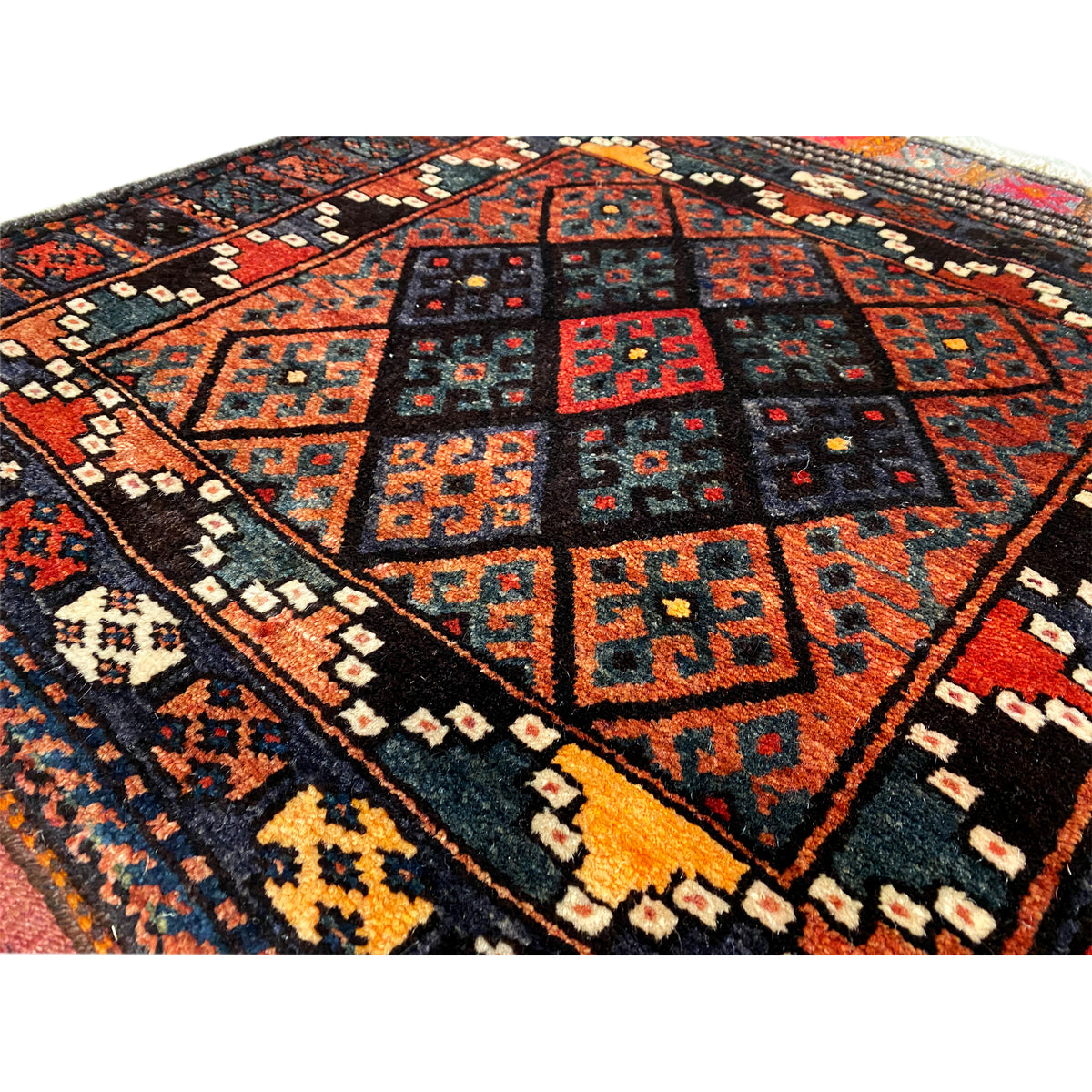Hamedan Poshti rug close-up: detailed square and diamond pattern in black and red
