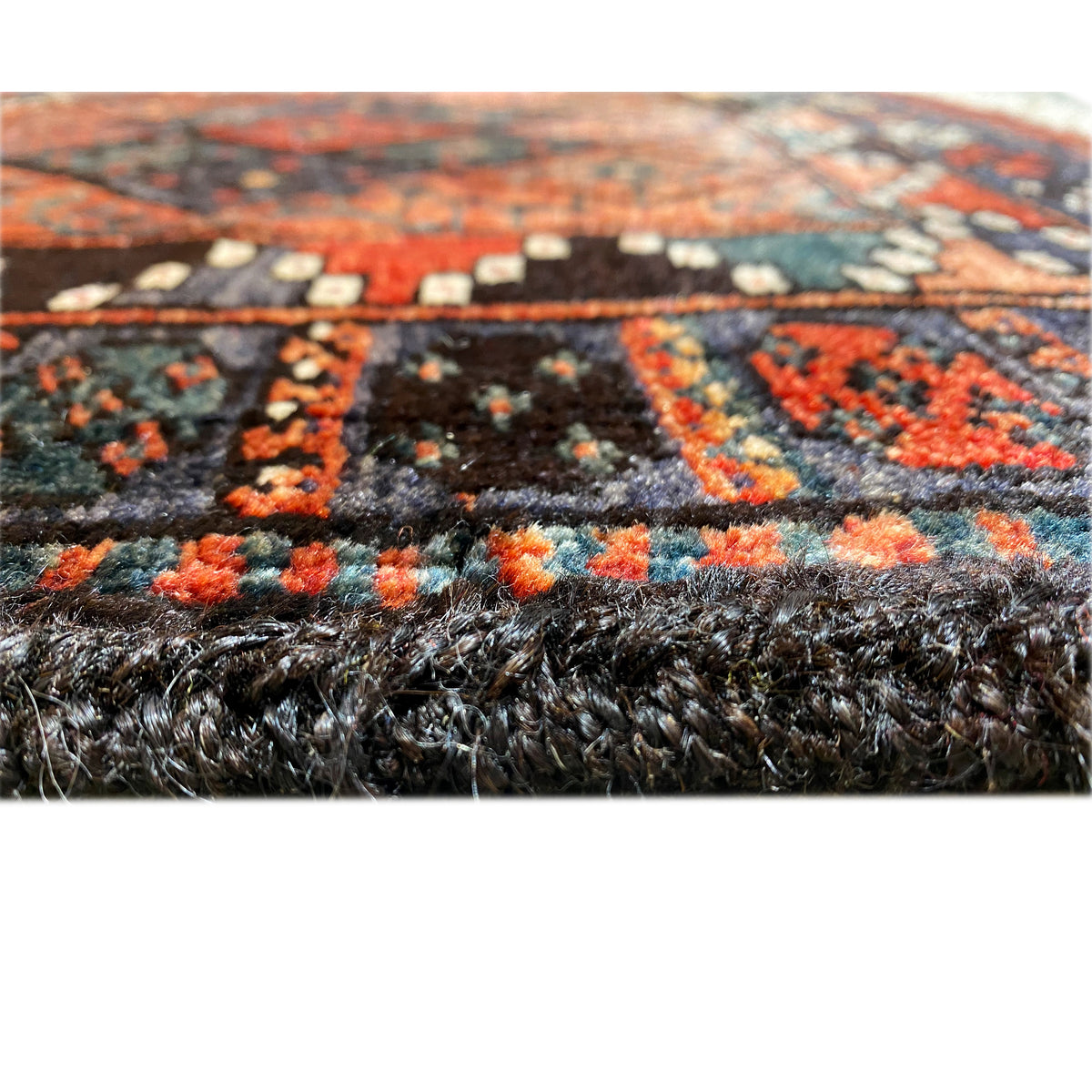 Hamedan Poshti rug, detail of the pile surface with a dark pattern and red accents