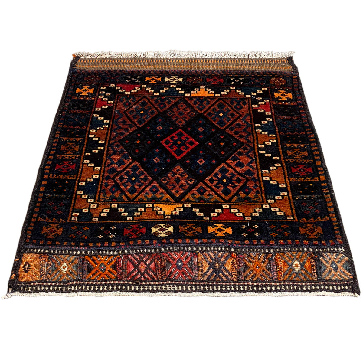 Rug, flat-woven, dark design with geometric patterns in red, blue, and orange