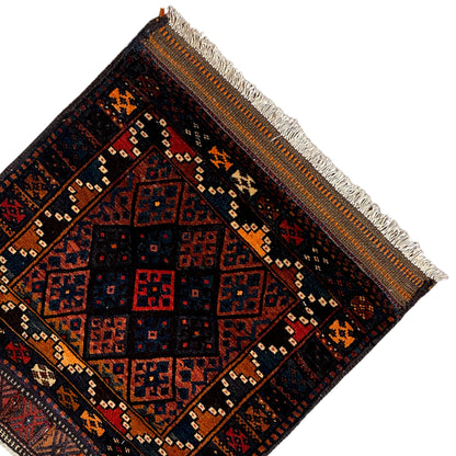 Rug from above, dark center with diamond and decorative patterns, fringes along the edge