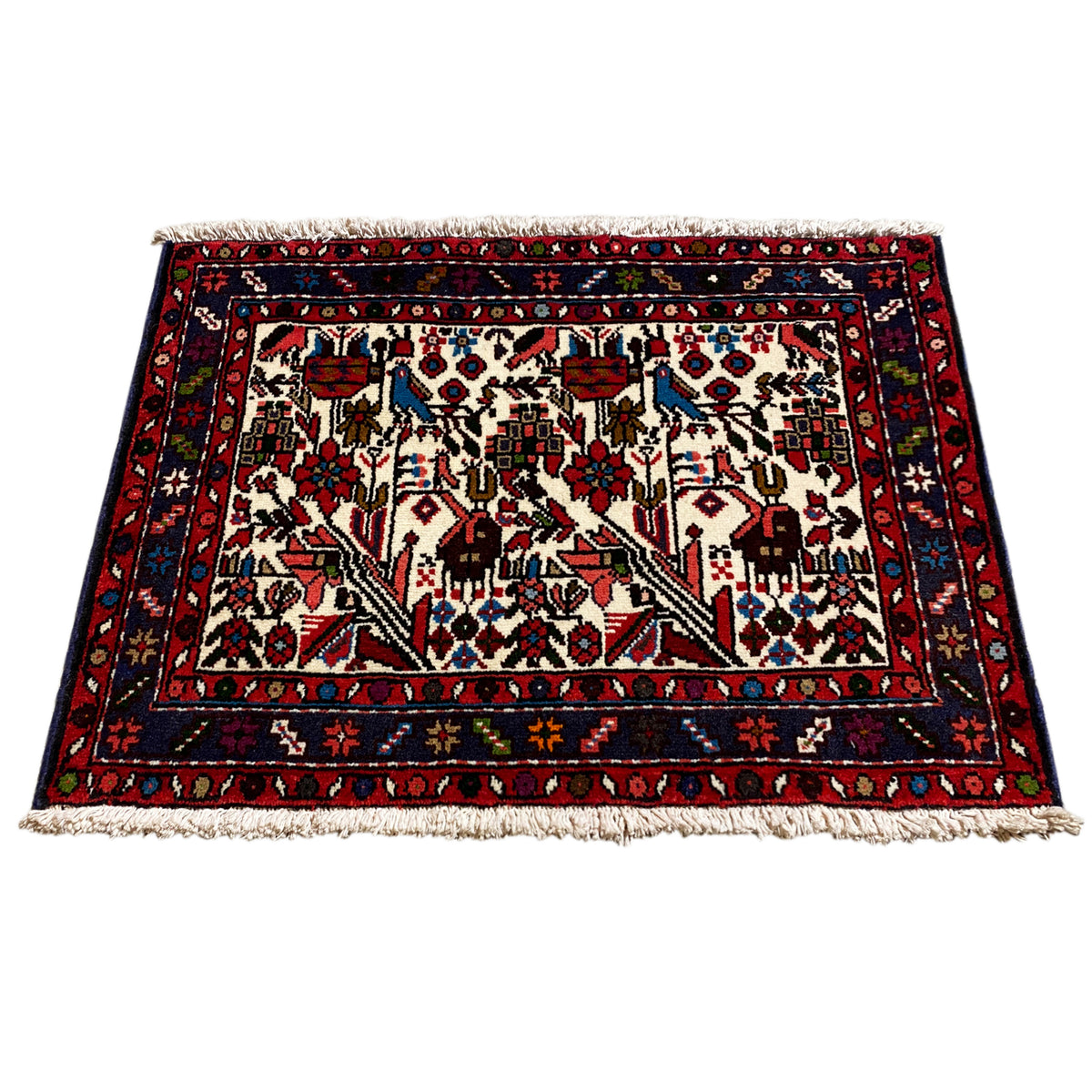 Oriental rug in a square layout, white field with floral motifs, red border