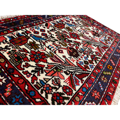 Close-up: Oriental rug with delicate ornaments, cream background, red-and-blue border