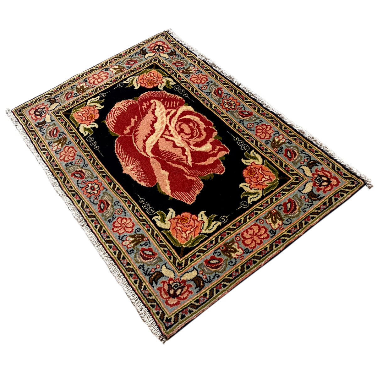 Hamedan Poshti rug at an angle, black background with red rose motifs in the medallion.