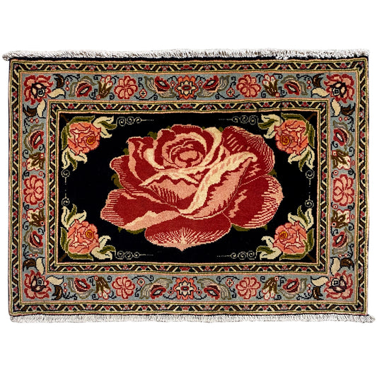 Hamedan Poshti rug with a black ground and a large red rose medallion front border.