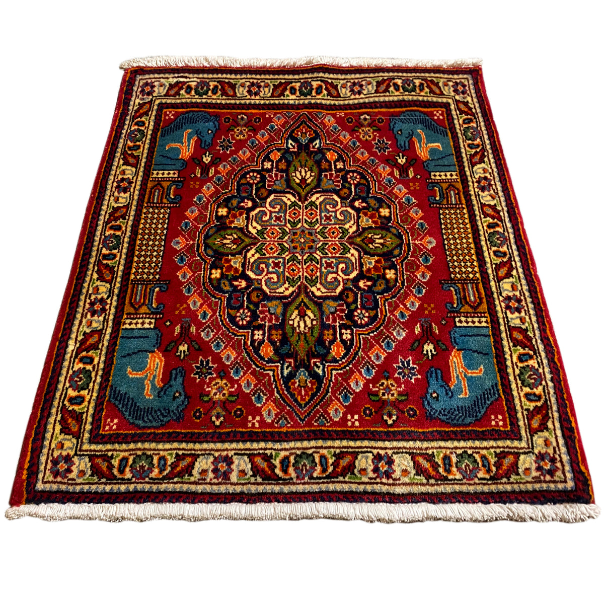 Square rug, red background with a blue pattern and animal motifs, wide cream border