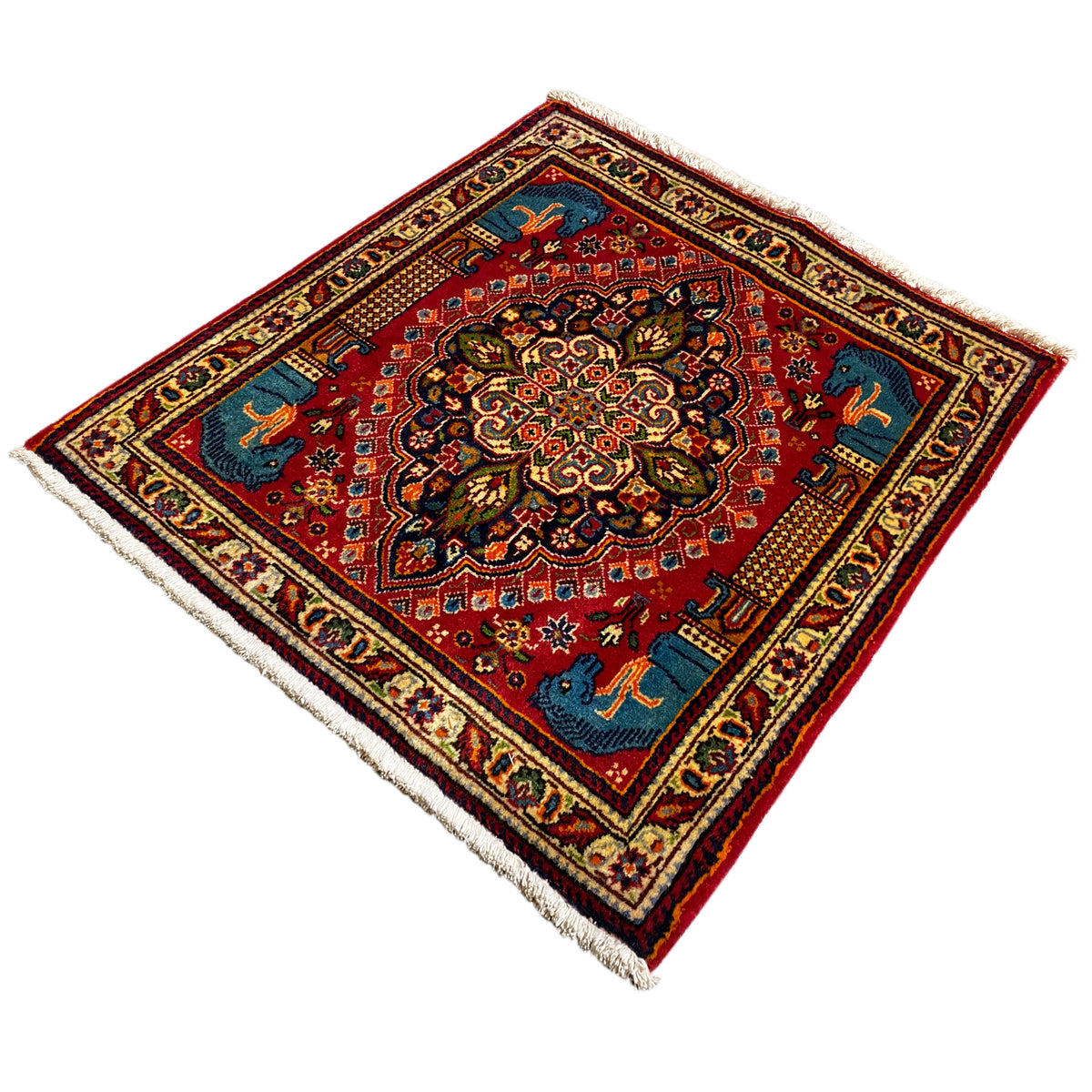 Carpet with a red background, richly decorated central motif, and blue animal figures, bordered in cream