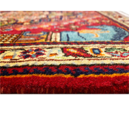 Rug detail from the side: dense pile with bold red and blue color blocks, patterned
