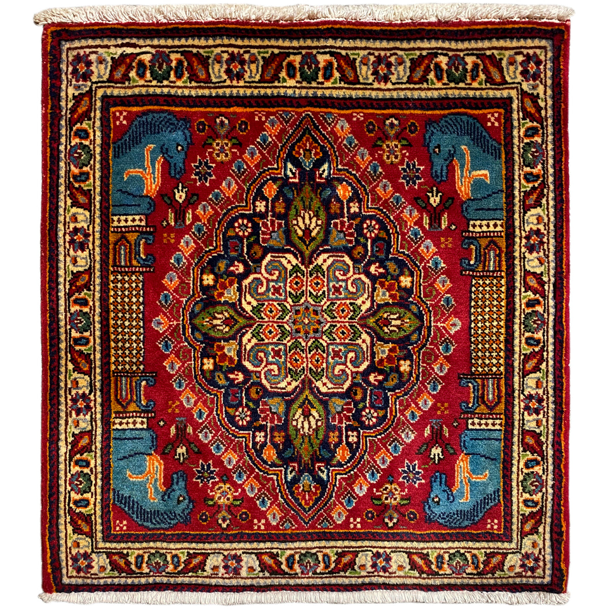 Rug with a red background, blue medallion, ornaments and animal motifs; cream-colored border