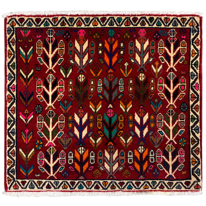 Poshti rug with a red background, multicolored tree and pattern design, fringed edge.