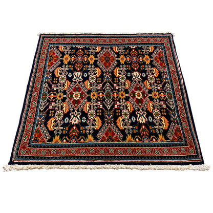 Rug 61x60 cm, flat-woven, dark background with a colorful pattern and a wide border.