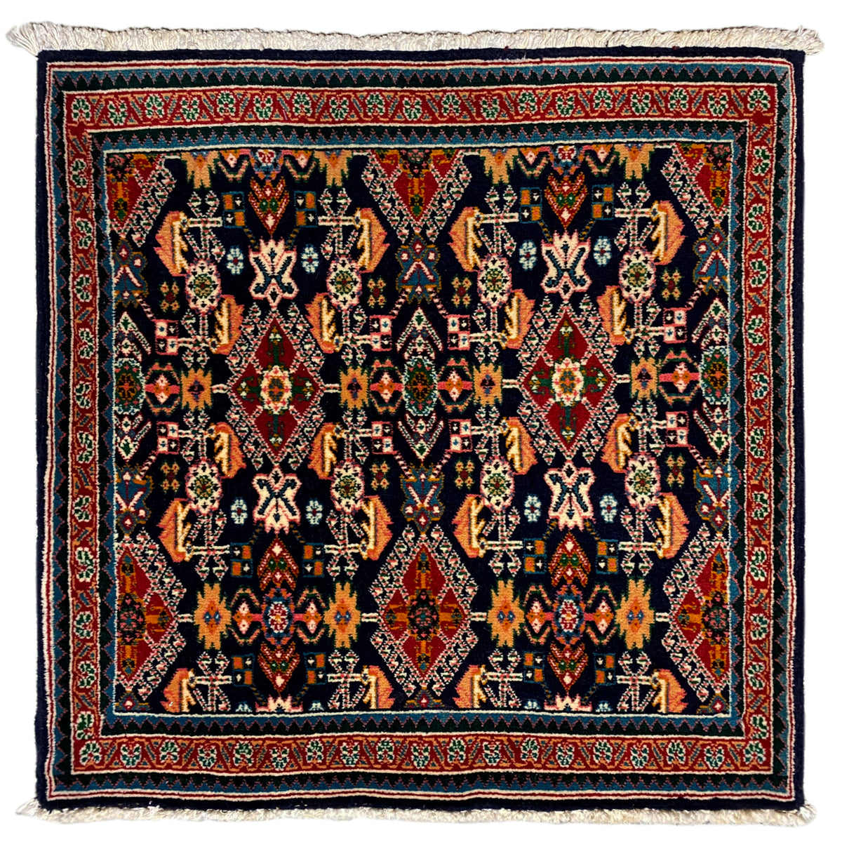 Rug 61x60 cm with geometric ornament in dark blue, red, and turquoise, with fringes.