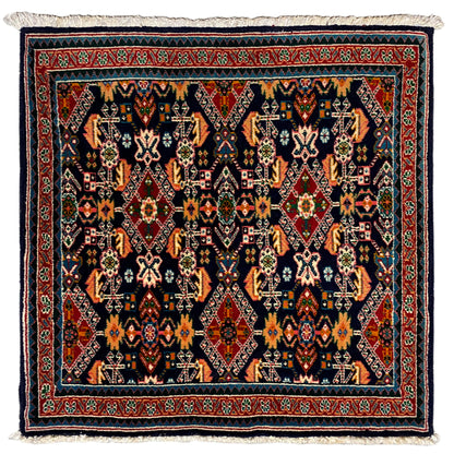 Rug 61x60 cm with geometric ornament in dark blue, red, and turquoise, with fringes.