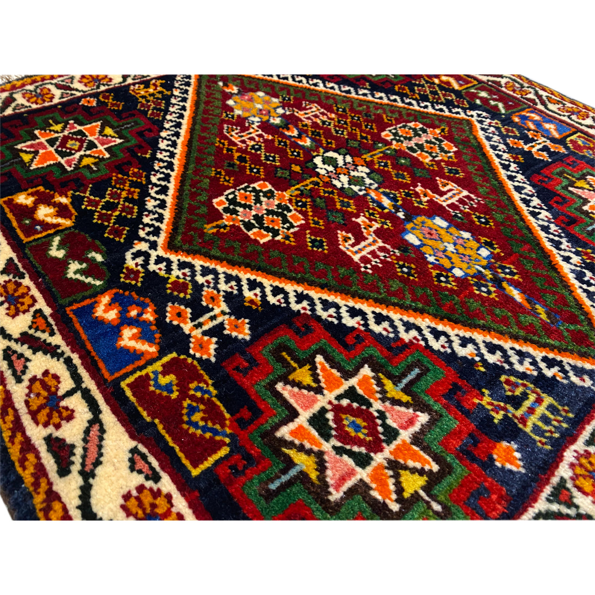 Close-up of Poshti rug 57x56 cm: colorful pattern of ornaments and lines, fringes