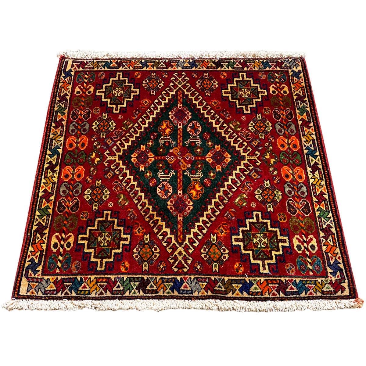 Burgundy Oriental rug with a geometric pattern and fringes along the edge