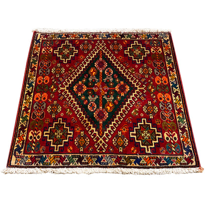 Burgundy Oriental rug with a geometric pattern and fringes along the edge