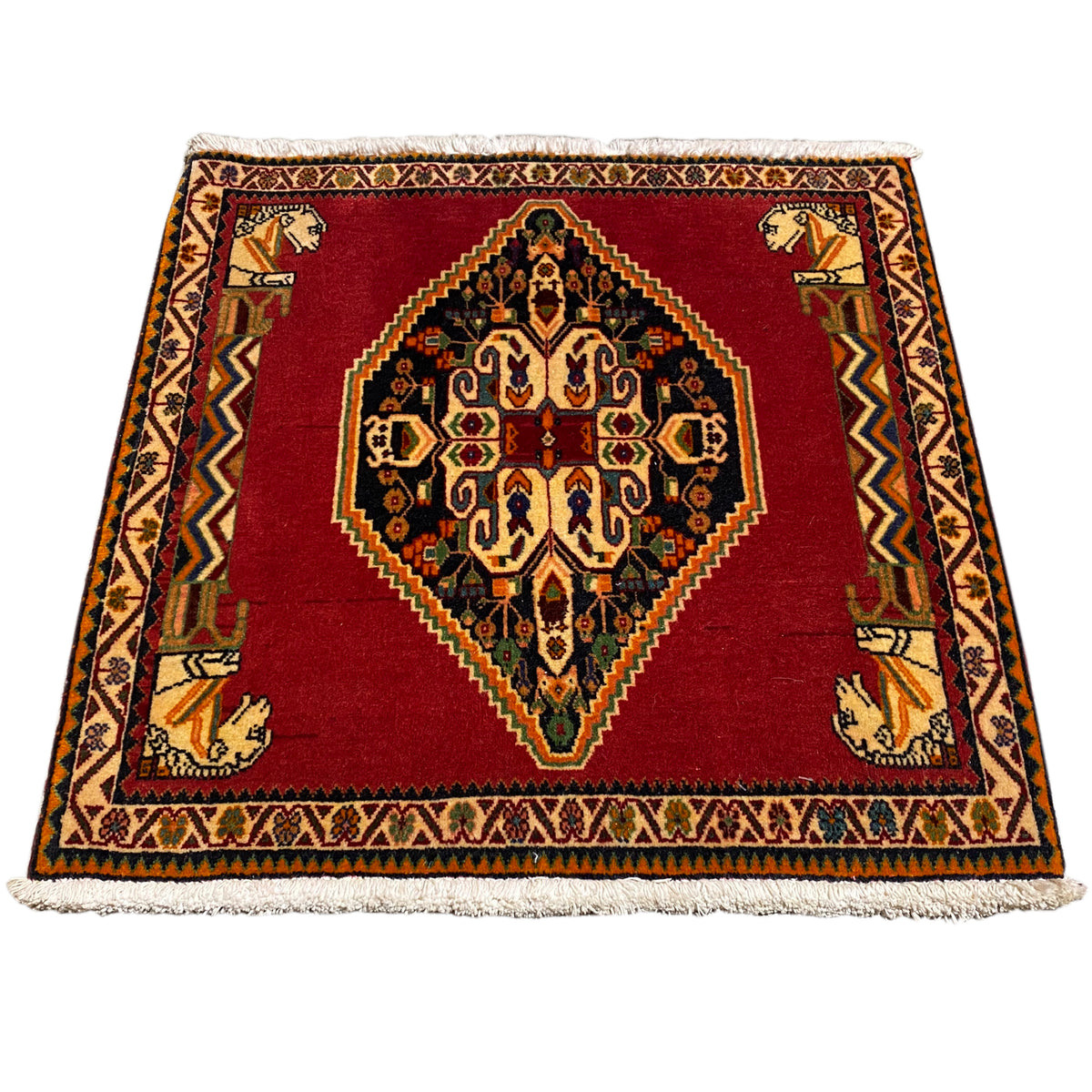 Rectangular rug laid out, red pattern with medallion, border and fringe