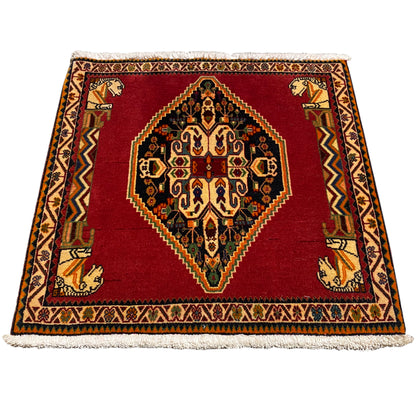 Rectangular rug laid out, red pattern with medallion, border and fringe