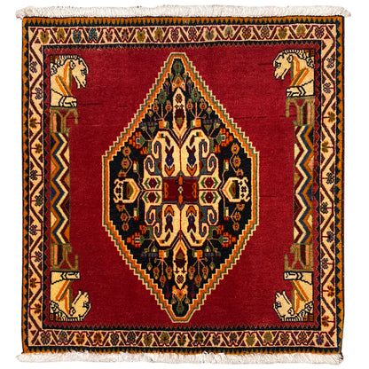 Rug with a red ground, central medallion, geometric border, and decorative fringe
