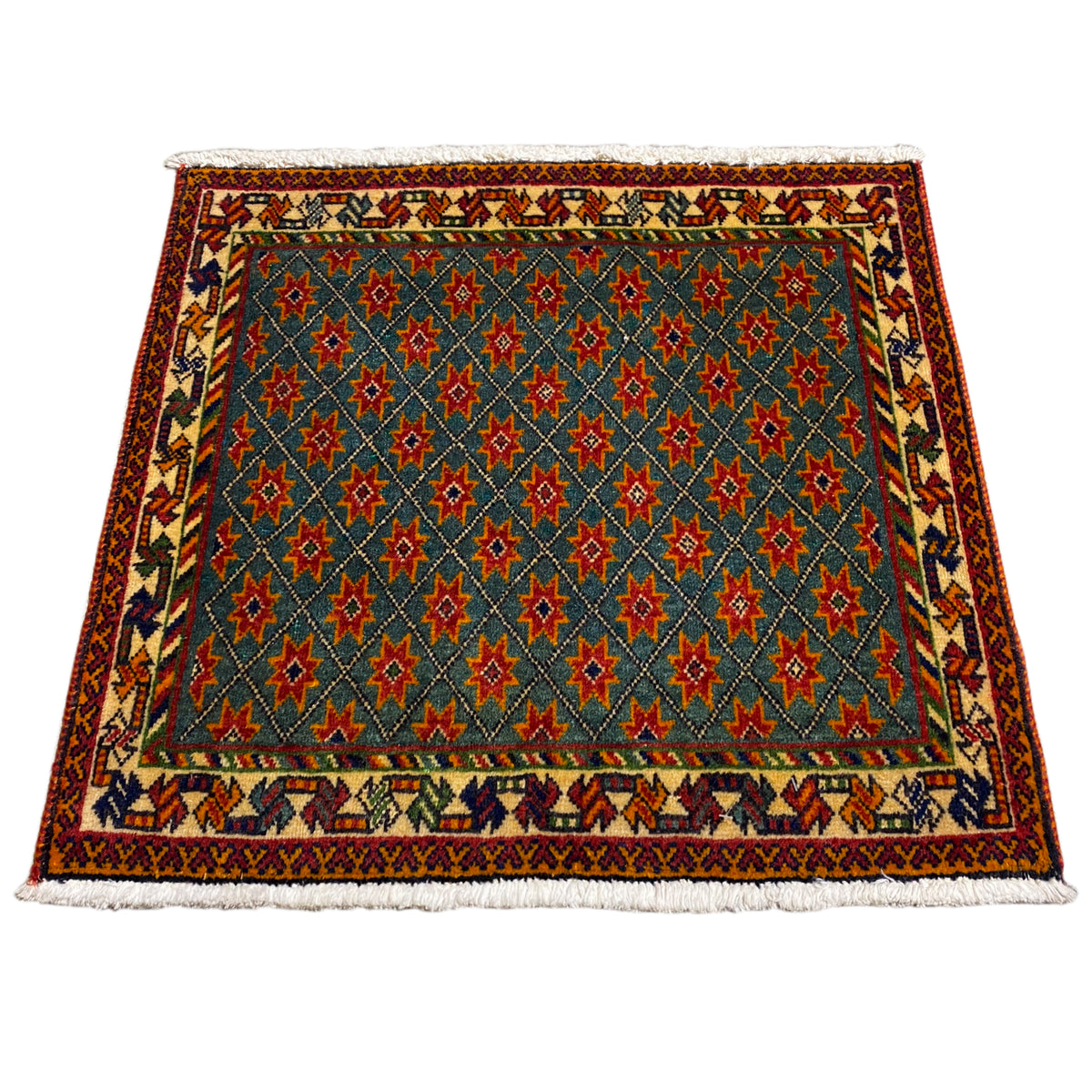 Rectangular rug with a blue background and multicolored star patterns, fringes