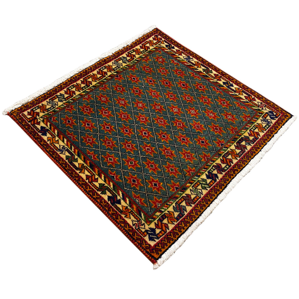 Rug with a blue vintage star pattern, multicolored border, diagonal view, fringes