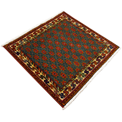 Rug with a blue vintage star pattern, multicolored border, diagonal view, fringes