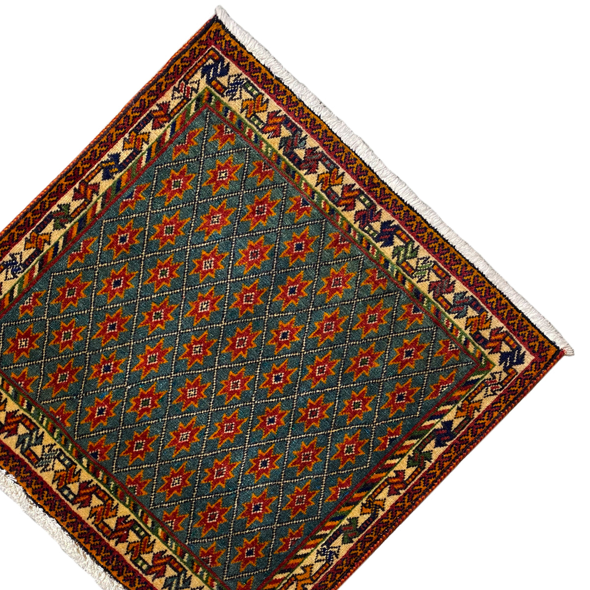 Carpet corner with a blue star pattern, ornamental border, white fringes