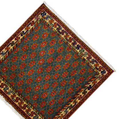 Carpet corner with a blue star pattern, ornamental border, white fringes