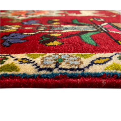 Poshti carpet (67x64 cm) close-up: red pile with colorful decorative stripes along the edge.
