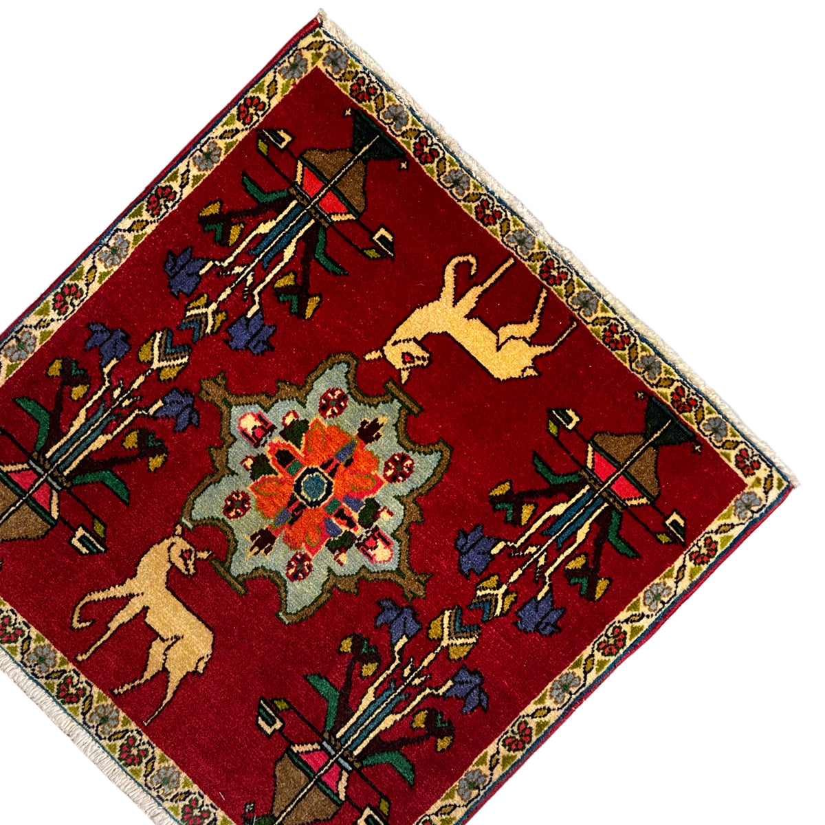 Poshti carpet (67x64 cm), angled: red field with a central floral rosette and animal motifs.