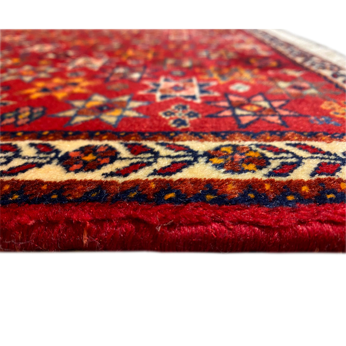 Poshti rug 59x56 cm, close-up of the edge with fringes and multicolored patterns