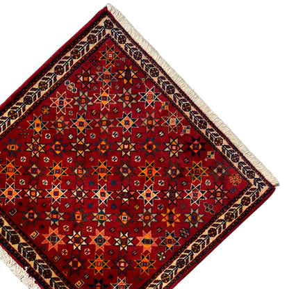 Poshti rug 59x56 cm, corner view with red pattern, border, and beige fringes