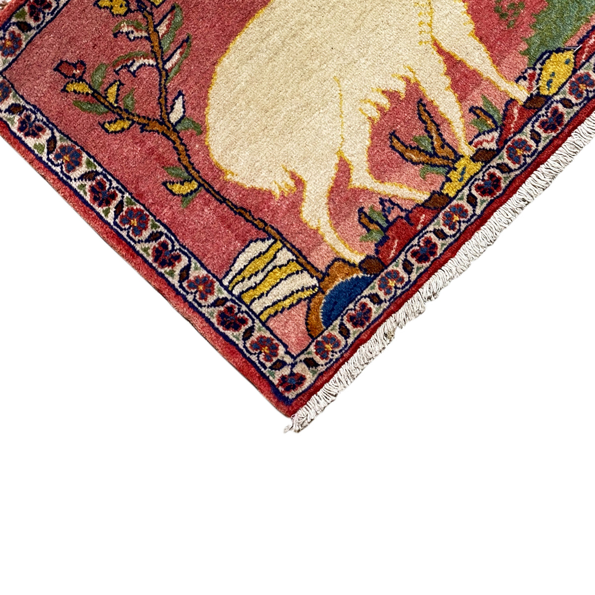 Rug corner with fringes and border ornaments, red field with an animal motif