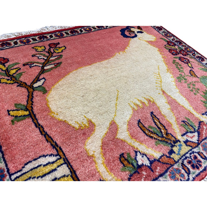 Close-up of a rug: soft pile with an animal motif, red-beige color gradient, colorful ornaments