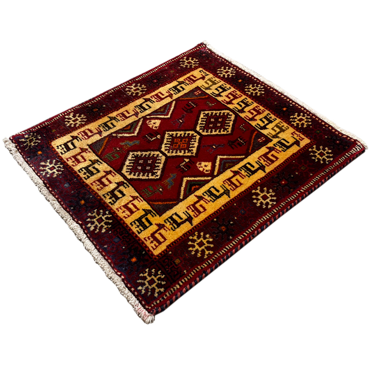 Dark red rug with a beige border, central diamonds, and short fringes