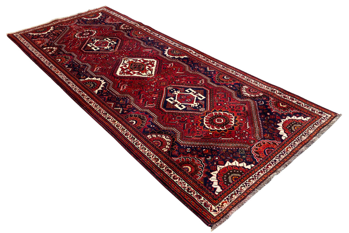 Oriental rug runner laid flat, red color pattern, dark blue lines and border