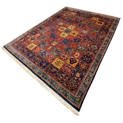 Qashqai rug in oblique view, multicolored tile pattern with fringes at the corners