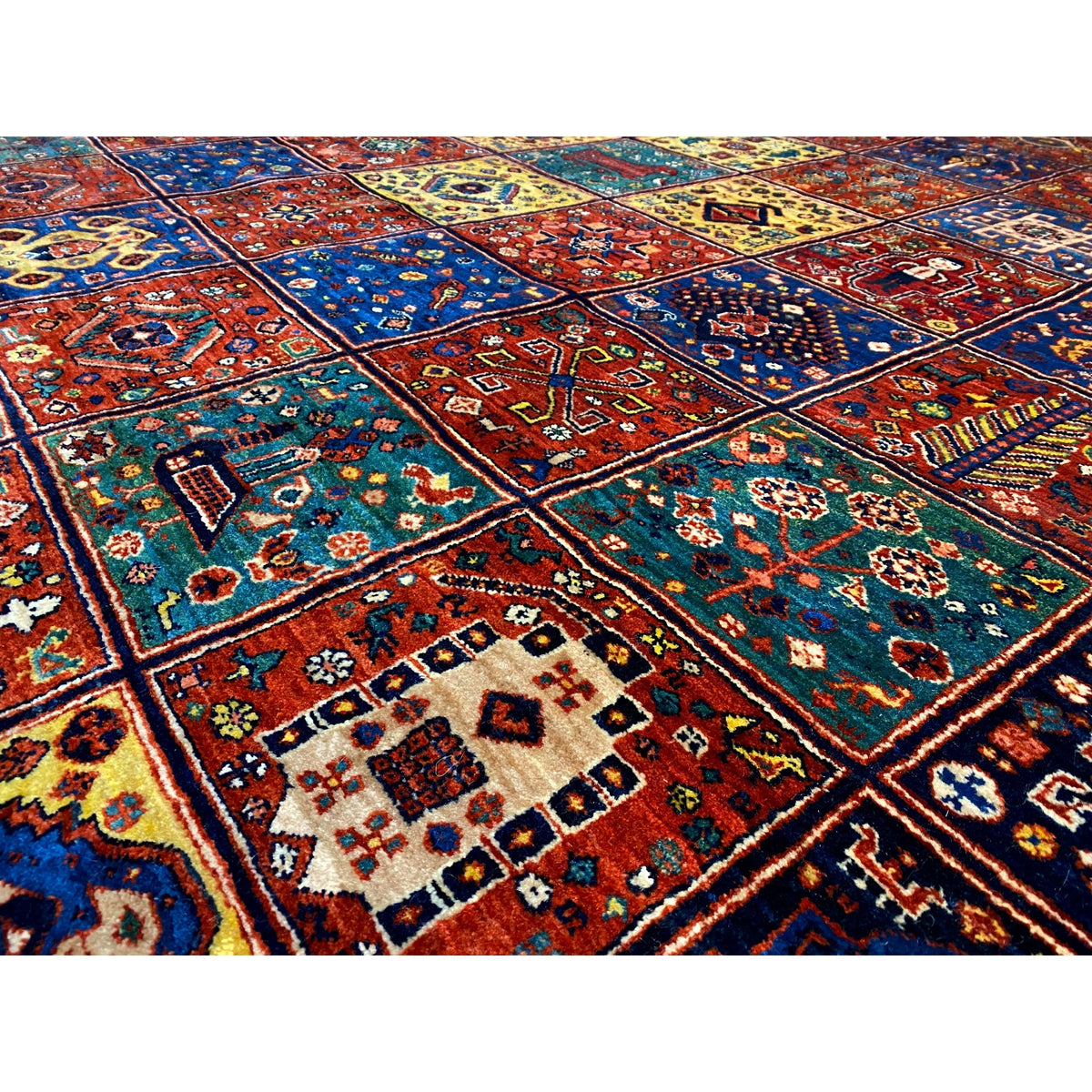 Detailed view: Qashqai rug, dense ornamental pattern in blue, red, yellow, and green