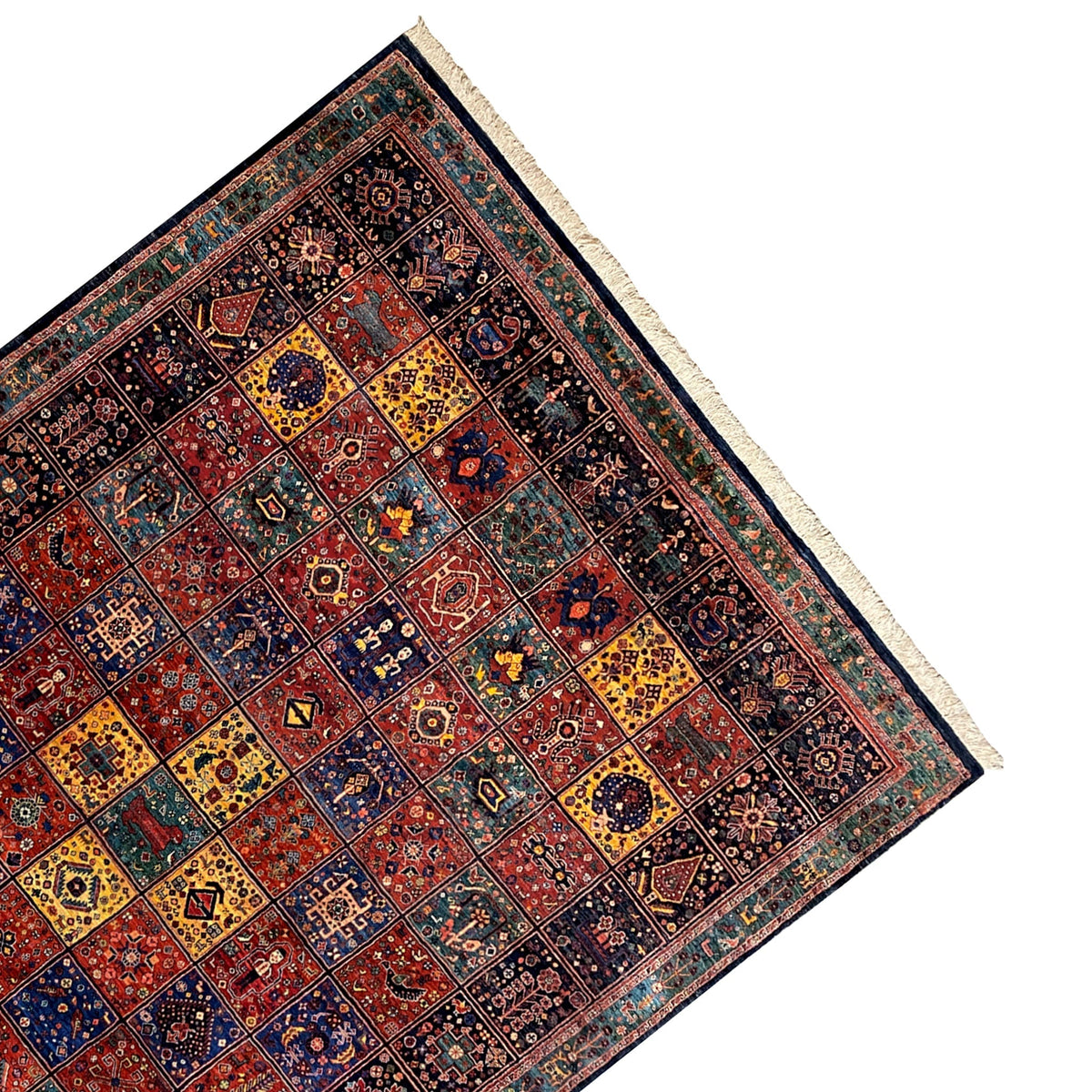 Qashqai rug corner in perspective, dark patterned rug with light fringes
