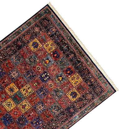 Qashqai rug corner in perspective, dark patterned rug with light fringes