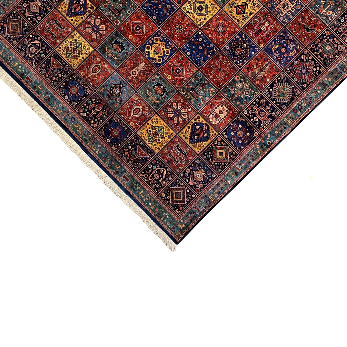 Qashqai rug corner close-up, colorful ornamental pattern and light-colored fringes