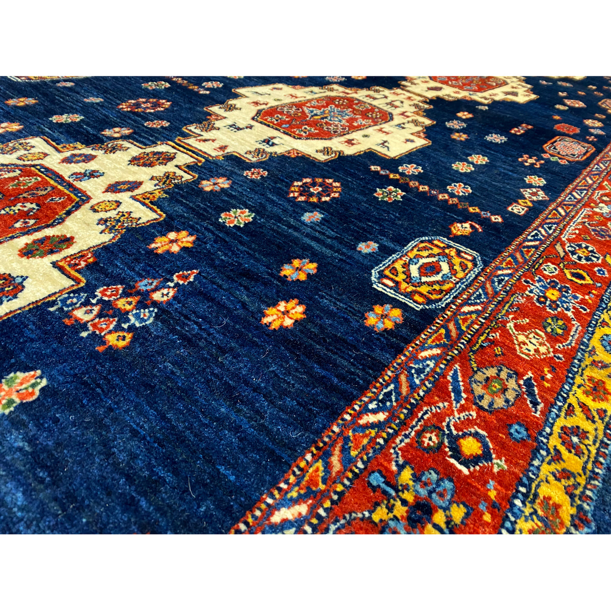 Close-up: dark blue rug with a colorful floral and patterned print