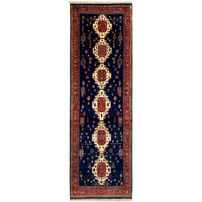 Runner rug with a dark blue background and a red and cream medallion pattern
