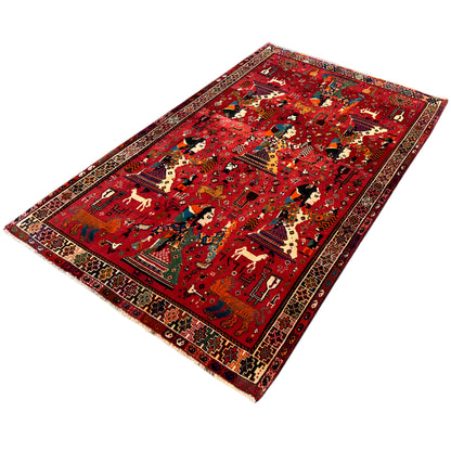 Red Qashqai rug with a large pattern, multicolored figures, and border ornaments