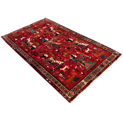 Red Qashqai rug with a woven central design, intricate border, and corners