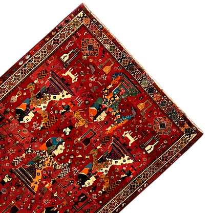 Qashqai rug corner with a red background, multicolored figures, and decorative border